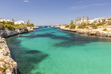 One of the beautiful bays with azure water in Ciutadella on the coast of Menorca in Spain