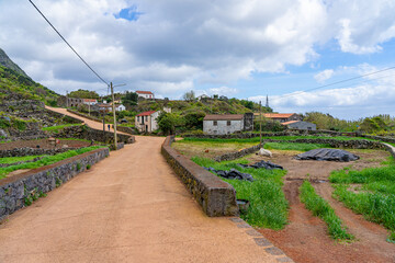 landscaped coastal area with typical stone houses in Fajã dos Cavalettes. São Jorge Island-Azores-Portugal.