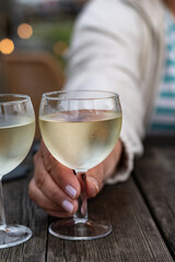 Tasting of Bordeaux white wine, right bank of Gironde Estuary, France. Glasses of white sweet French wine served in outdoor restaurant