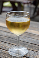 Tasting of Bordeaux white wine in Sauternes, left bank of Gironde Estuary, France. Glasses of white sweet French wine served in outdoor restaurant