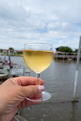 Tasting of Bordeaux white wine, right bank of Gironde Estuary, France. Glasses of white sweet French wine served in outdoor restaurant on oysters farm in Gujan-Mestras, Arcachon bay