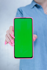 Woman's hands holding a large smartphone