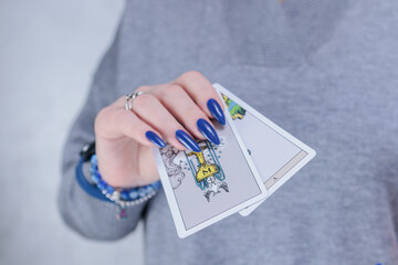 Female hands holding tarot cards for fortune telling and tricks