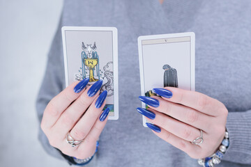Female hands holding tarot cards for fortune telling and tricks