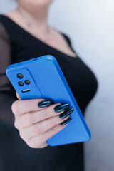 Woman's hands holding a large smartphone
