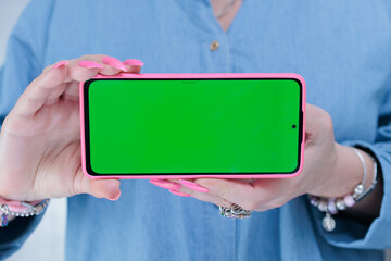 Woman's hands holding a large smartphone