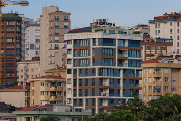 Fototapeta premium Southern cityscape, view of buildings and houses with green plants in public places in Turkey, sunny summer day in the city of Istanbul