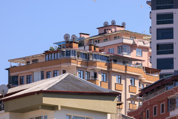 Cityscape, view of buildings and houses with green plants in public places in Turkey, sunny summer day in the city of Istanbul