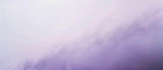 Fototapeta premium Fluffy white and purple clouds are forming interesting shapes on a bright pastel colored sky. The serene and peaceful atmosphere is perfect for a relaxing afternoon