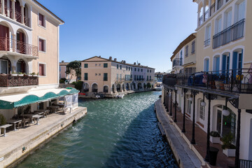 Downtown of Port Grimaud in France with cafes, restaurants, yachts and sailboats in spring