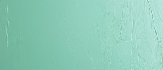 Obraz premium Subtle textured background is being formed by a refreshing mint green painted stucco wall. This cool color palette adds a touch of sophistication and tranquility to any design project