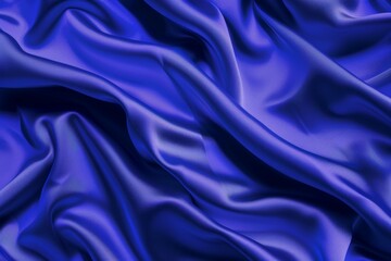 Fototapeta premium Luxurious blue satin fabric is flowing and forming soft folds, creating a beautiful and elegant background. This high-quality material is perfect for adding a touch of sophistication to any design