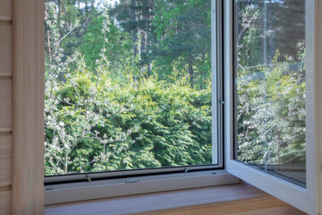 Fototapeta premium White window with mosquito net in scandinavian wooden house.