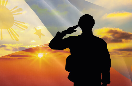 Silhouette of a soldier with a background of the Philippines flag and a sunset or sunrise. Concept of national holidays. Commemoration Day.