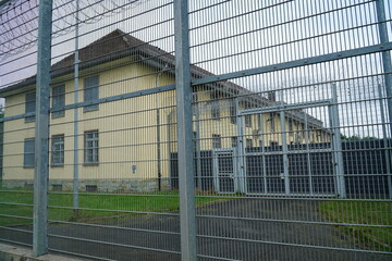 High fence and barbed wire in front of the deportation center, border protection, deportation custody at Hanover Airport, Germany.