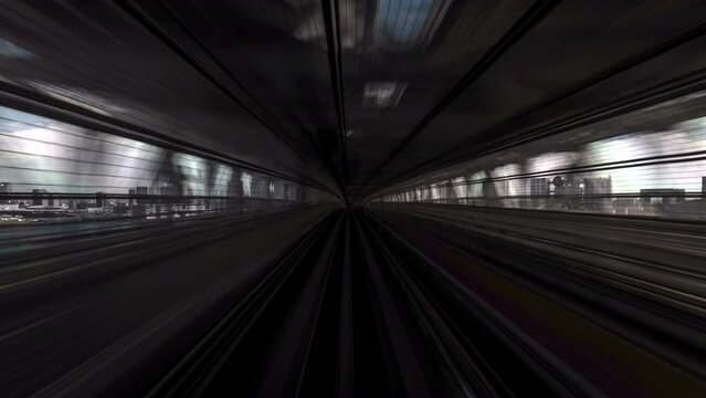 Motion timelapse POV shot from automated train during daytime in Tokyo, Japan.