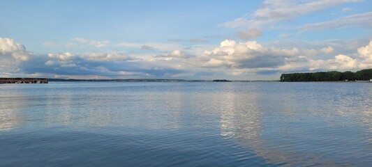 Sea, beach and pebbles, clouds in the sea.