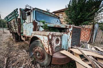 Side View of an Old Blue Truck Left to Rust in a Village Environment