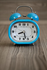 Vintage Blue Alarm Clock on Wooden Table, Classic Timepiece Design
