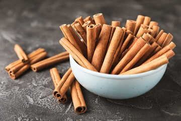 Cinnamon sticks on a textured wooden background. Cinnamon roll. Spicy spice for baking, desserts and drinks. Fragrant ground cinnamon. cinnamon powder Close-up. Place for text. copy space
