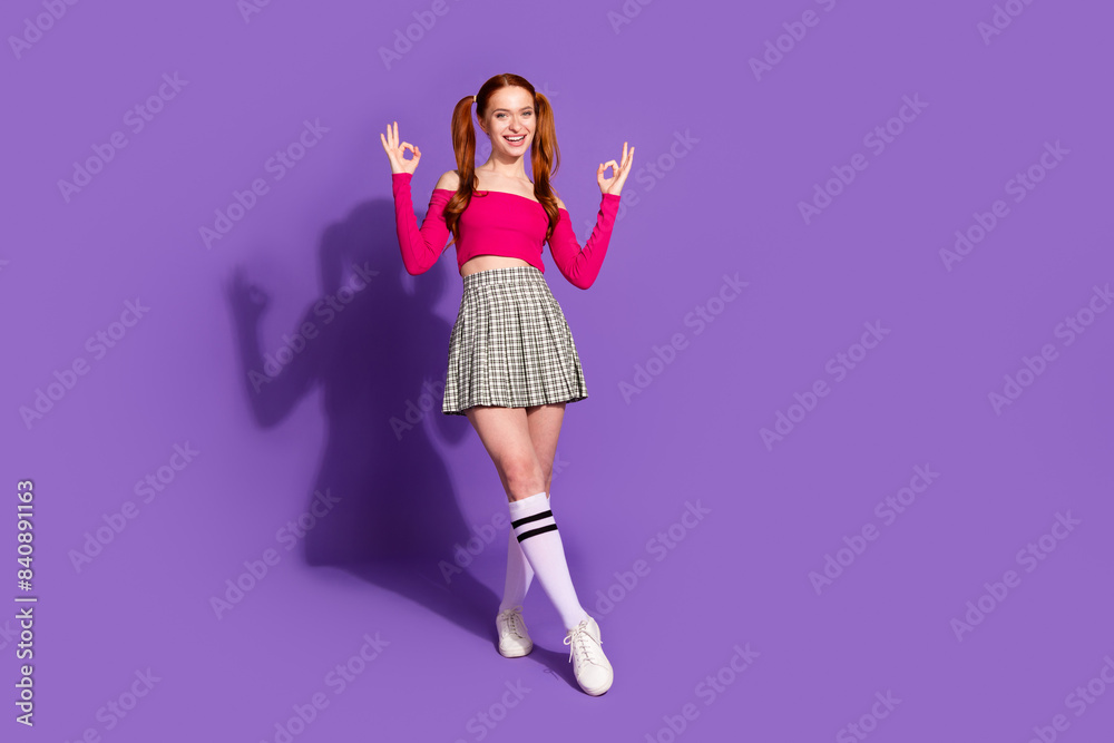 Wall mural full body photo of pretty young girl posing show okey wear trendy pink outfit isolated on purple col