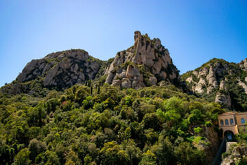 View of one of the peaks with uniquely shaped rock formations on Montserrat Mountain in Catalonia, near the funicular station