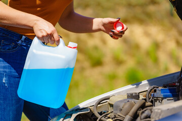 Pouring antifreeze liquid for washing car screen