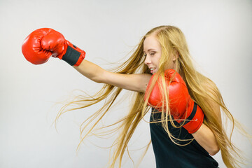 Woman in red gloves boxing