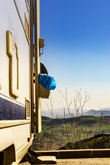 Camper door with trash can.