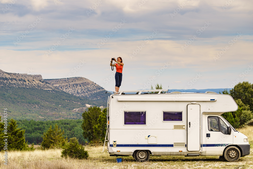 Canvas Prints Woman traveling with caravan, taking photo from rv roof