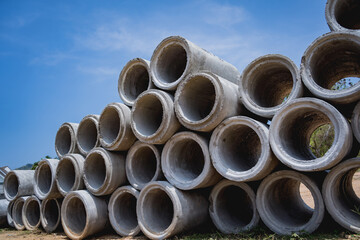 A stack of concrete ring pipes piled and creating a symmetrical arrangement