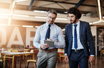 Business people, tablet and talking or walking in office with discussion for project management and client briefing. Manager, employee and networking with digital tech for teamwork on corporate ideas