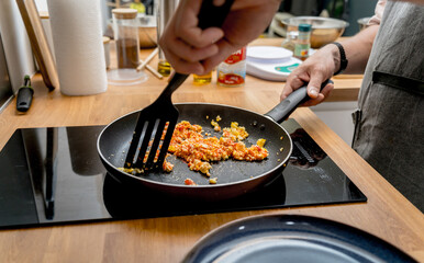 Chef at the kitchen preparing quesadillas with tofu and sweet corn