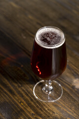 dark beer in a glass glass, fresh dark alcoholic beer
