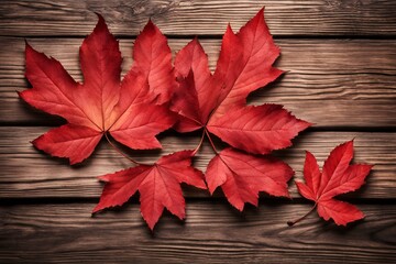 Obraz premium Autumn leaves on wooden background, vibrant red and orange foliage, fall season decor, natural wood texture, seasonal design, colorful leaf arrangement, nature-inspired backdrop, cozy autumn