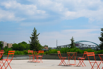 public seating areas for lunch and relaxation, metal chairs and tables in the park, comfortable landscaping and travel lifestyle