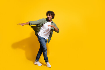 Portrait photo of young funny mexican guy in khaki shirt dancing rhythm cool performer at...