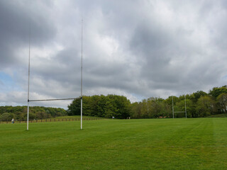 Obraz premium Tall goalpost on a training ground for Irish National sports. Camogie and hurling pitch. Sport ground in a public park in Ireland.