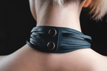 back view of naked woman in black leather bdsm collar, nude female in seductive role playing game...