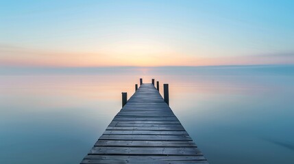 Obraz premium A serene wooden pier stretches into a calm sea under a pastel-colored sunrise. Capture tranquility and simplicity in this peaceful moment. Perfect for nature lovers and relaxation themes. AI