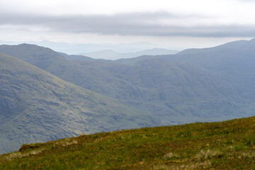 Obraz premium Panoramic view from Devils Ladder, one of most difficult trails, that is leading to highest Irish mountain Carrauntoohill or Carrantuohill is the highest mountain in Ireland at 1038m in Ring of Kerry