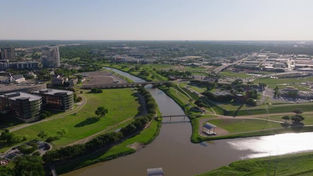Trinity River in Fort Worth, Texas, from an aerial point of view. Urban landscape, green spaces, and modern architecture in a bright day