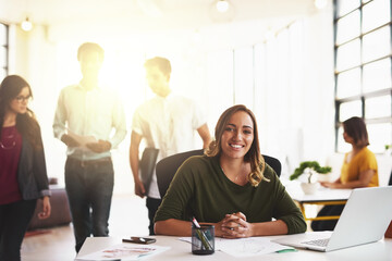 Fototapeta premium Business woman, smile and portrait with laptop at desk in office for creative startup company. Face, happy professional and technology for graphic designer, entrepreneur or web designer agency