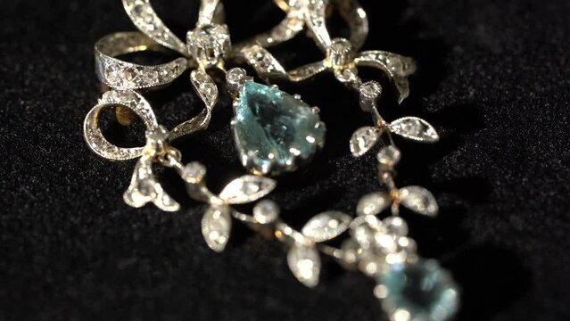 Gold and platinum antique art nouveau brooch and necklace close up video on black background 