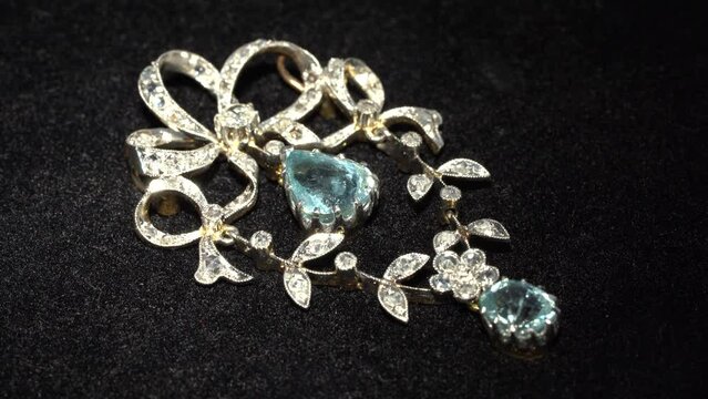 Gold and platinum antique art nouveau brooch and necklace close up video on black background 
