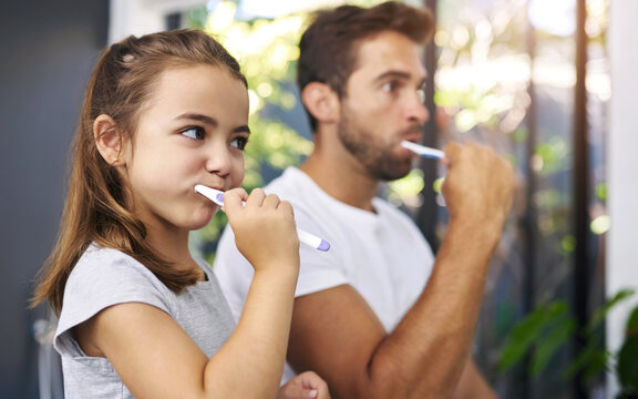 Bathroom, brushing teeth and father with girl, cleaning mouth and morning routine with hygiene. Family, dad and daughter with fresh breath, grooming and oral care with dental wellness and home