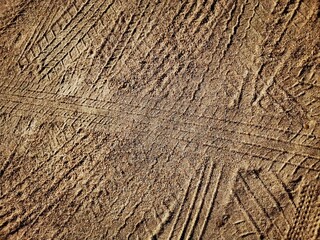 Wheel tracks on the soil road background or texture