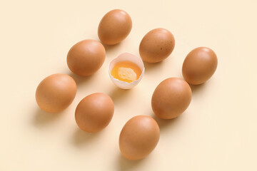 Raw chicken eggs on yellow background