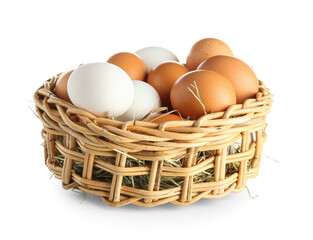 Wicker bowl with raw chicken eggs on white background