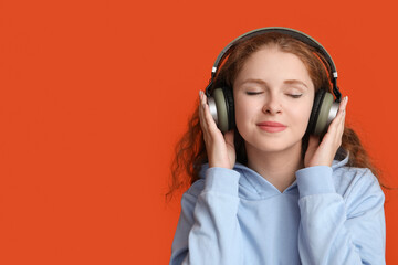 Portrait of relaxed young woman listening to music on red background
